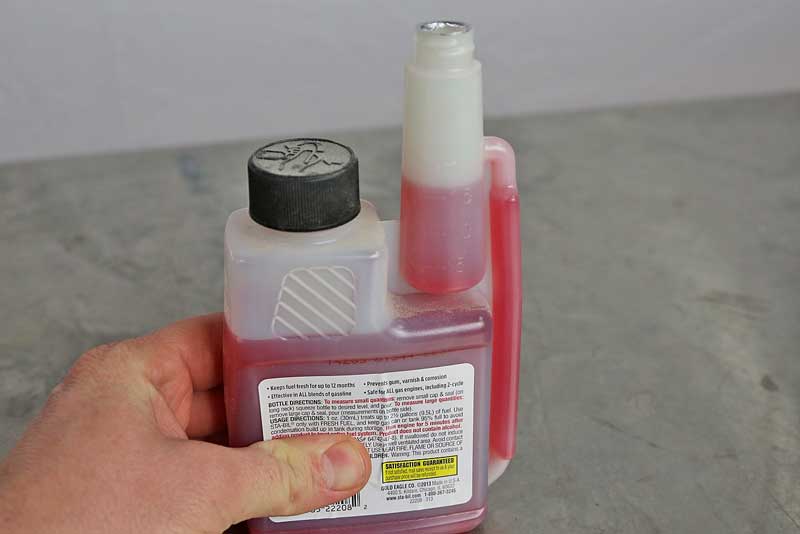 Leave the large cap tight, and then squeeze the bottle slowly to fill the dispenser to the level you need.