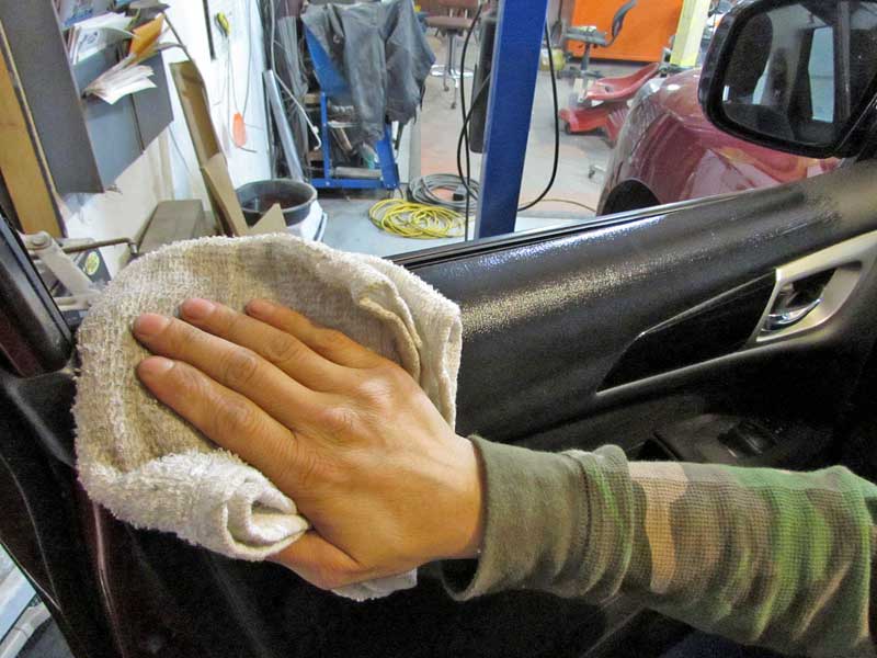 Wipe the panel with the towel to apply 303 Protectant.