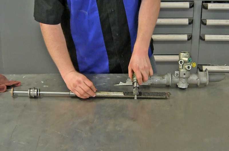 Inside the steering rack is the pinion gear which rides on the rack gear as shown. The pinion gear is also part of the hydraulic valve.